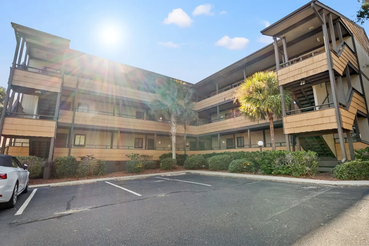 This image depicts the exterior of Mariners Cove, showcasing the welcoming building structure framed by tall palm trees and illuminated by warm sunlight. The environment suggests a calm, inviting atmosphere and hints at opportunities for leisurely outdoor activities.